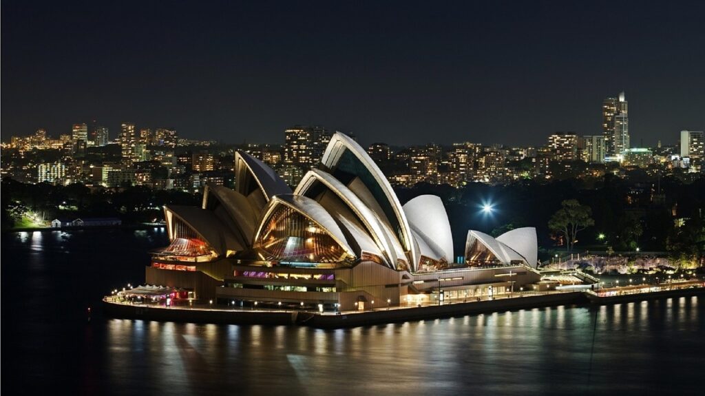 Sydney Opera House lit up at night.