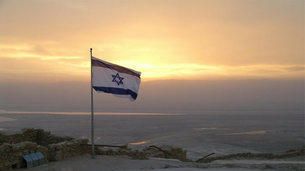 Israeli flag overlooking an Israeli sunset.