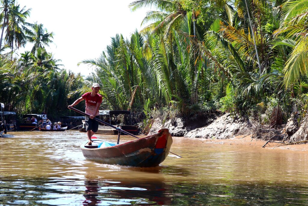 Man boating on the Mekong Delta in Vietnam.