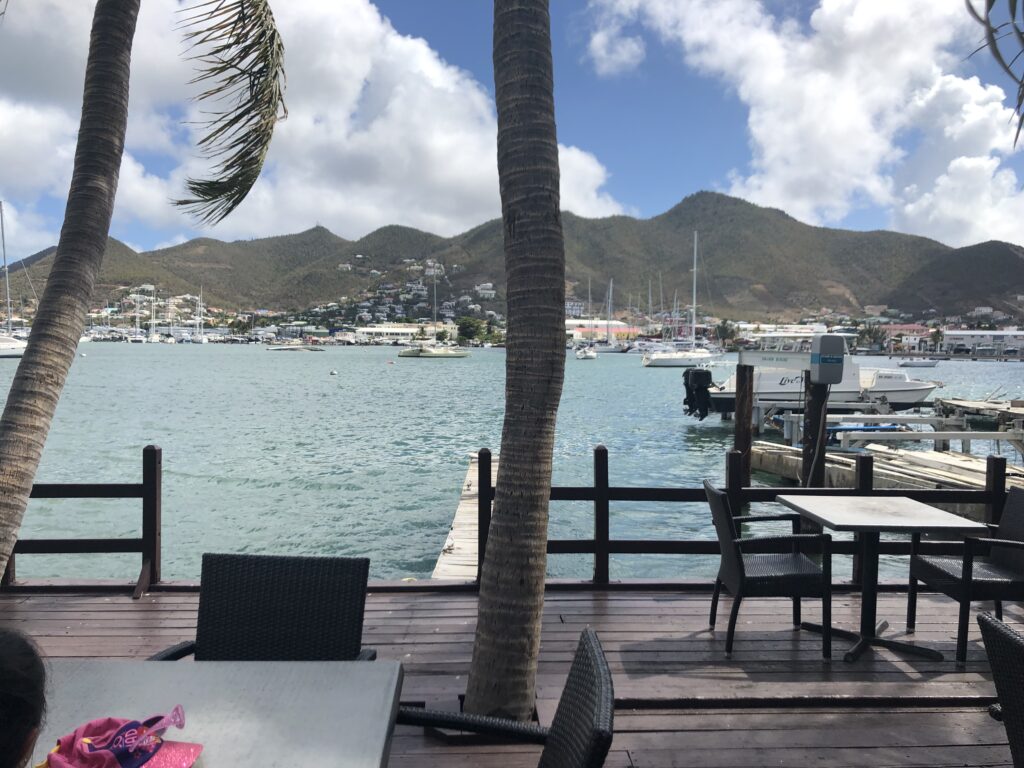 Cafe patio view of bay with small boats.