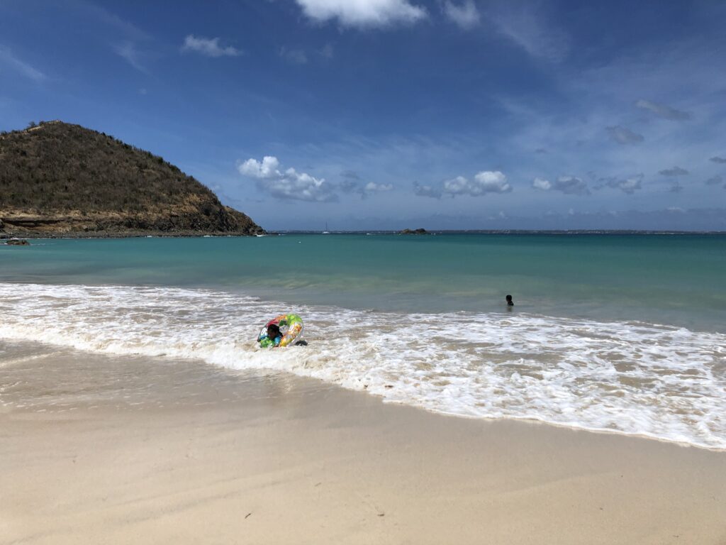 Two children swimming in the sea at Anse Marcel in St. Martin.