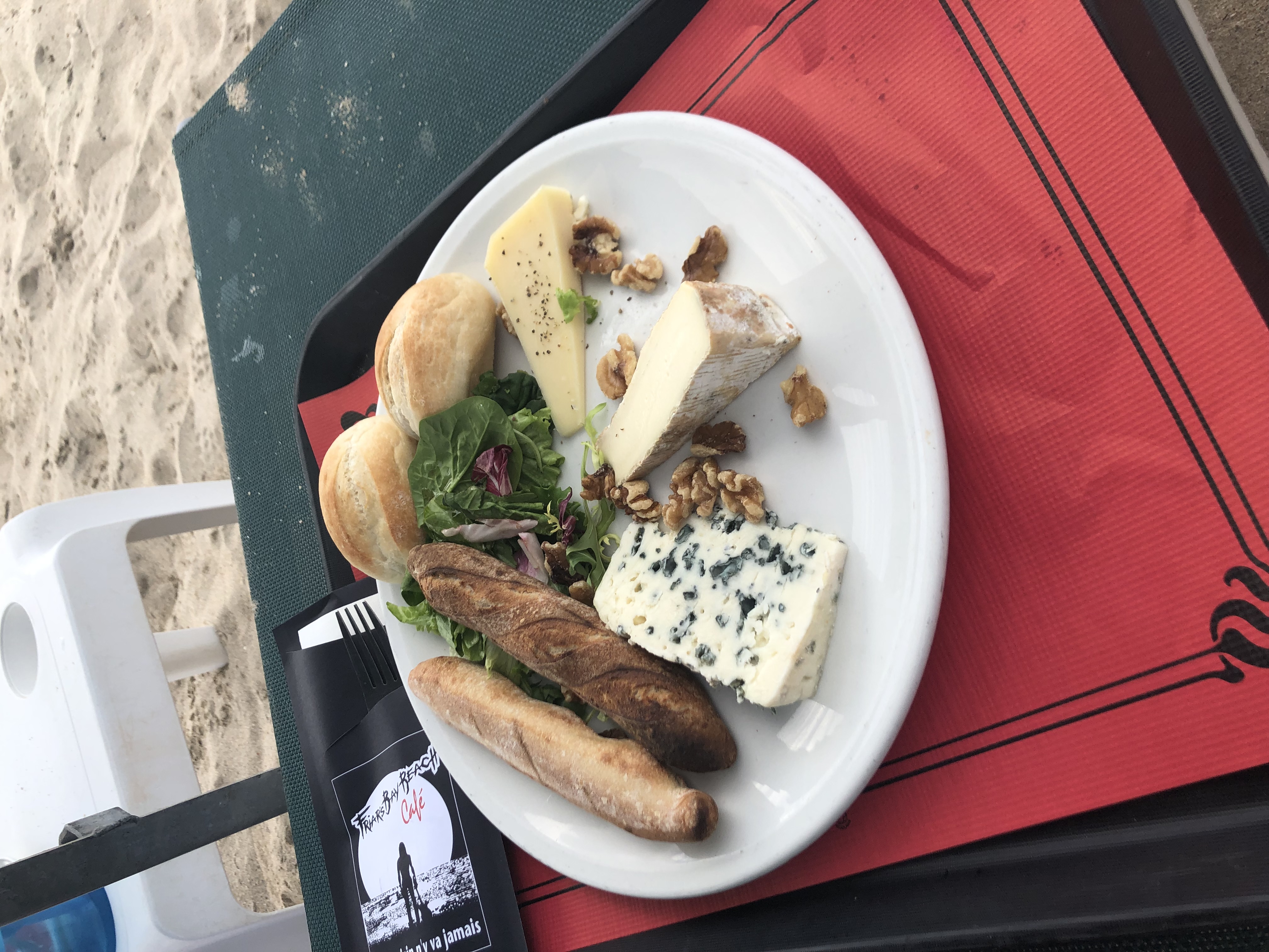 Charcuterie plate with bread, cheese and nuts.