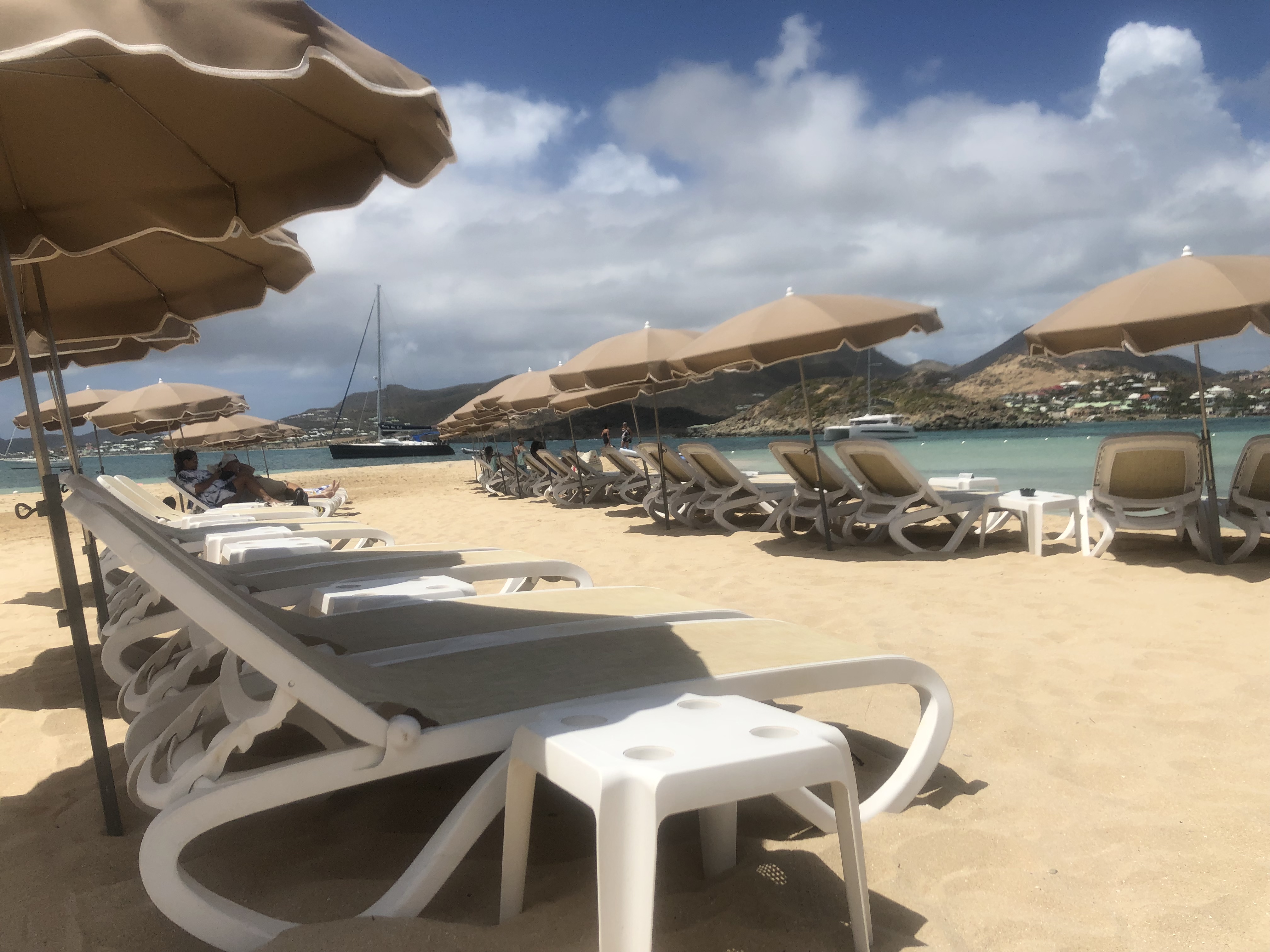 Beach chairs and umbrellas lining the sand on Pinel Island.