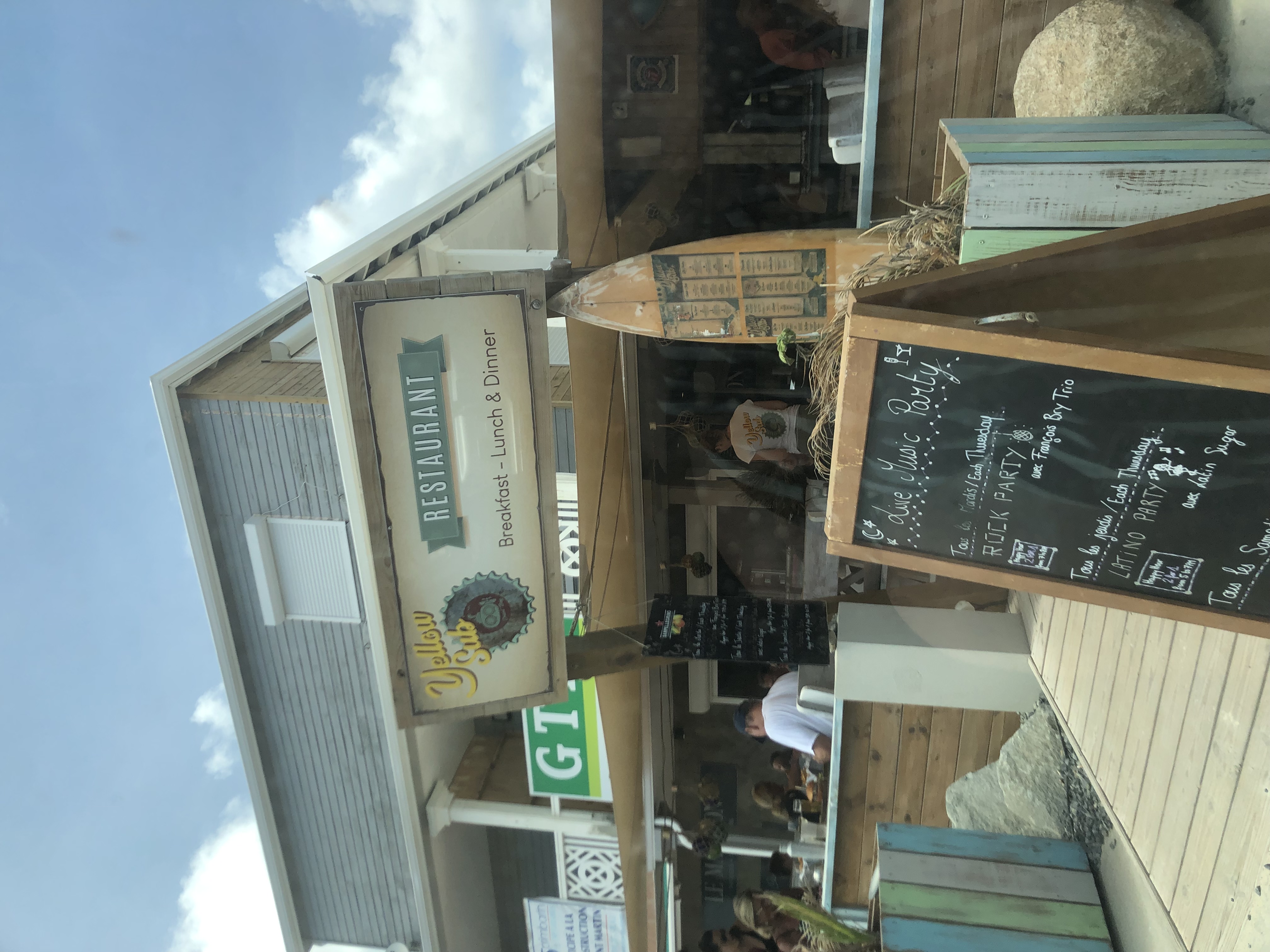 Entrance sign to restaurant with chalkboard menu in foreground.