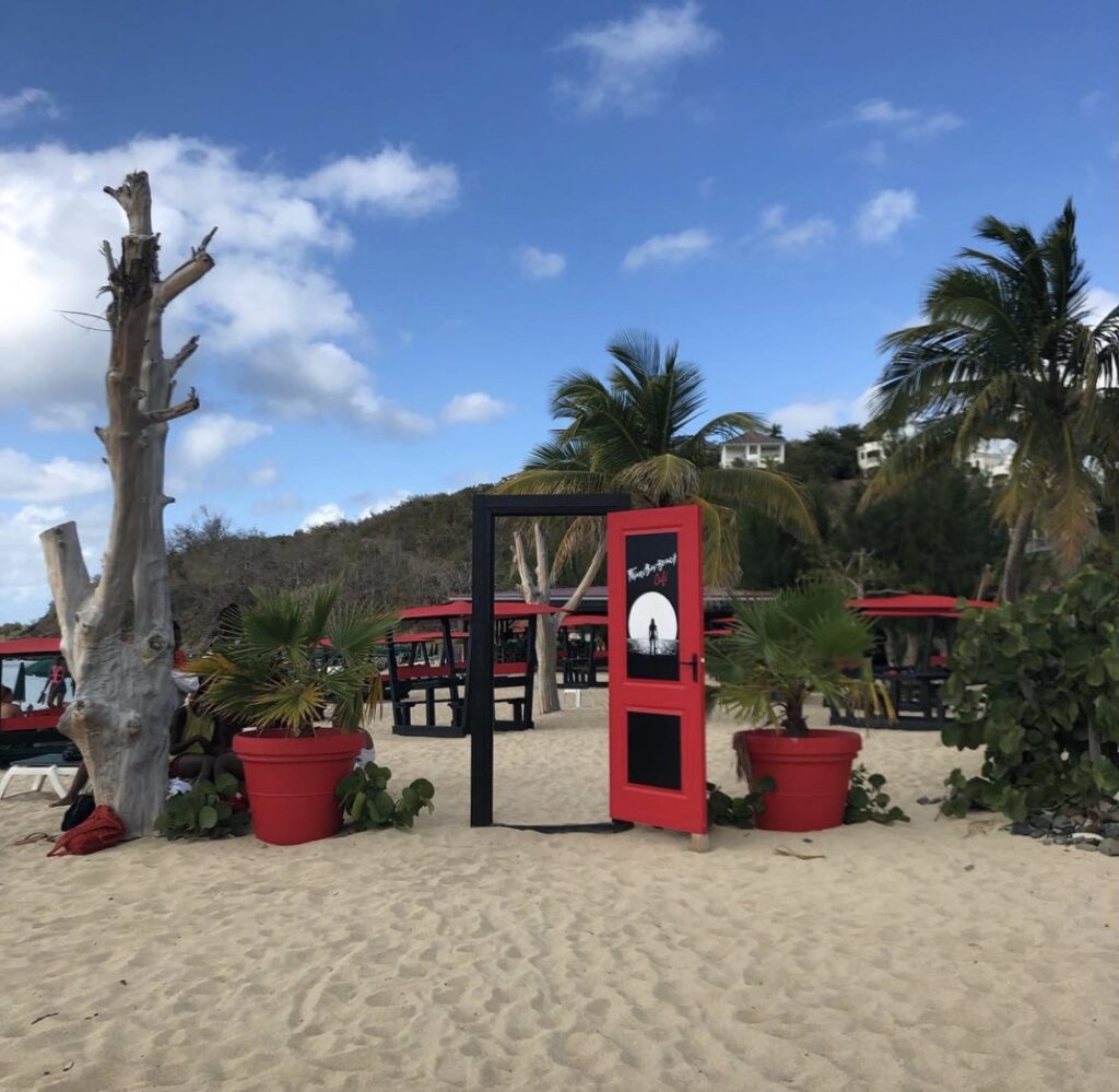 Stylish red and black entrance to restaurant on the beach in St. Martin.