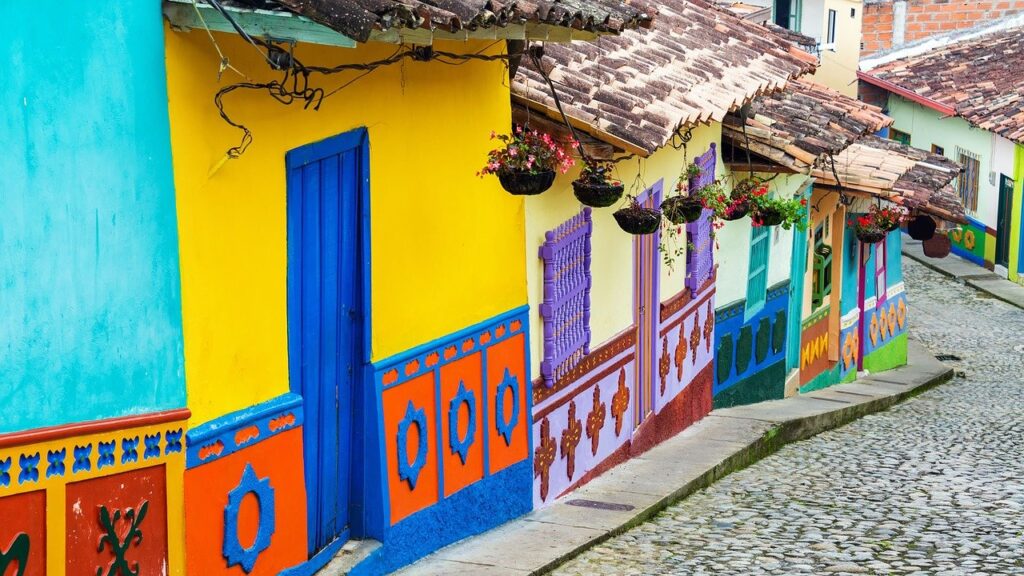 Colorful buildings set on a descending cobblestone road in Columbia.