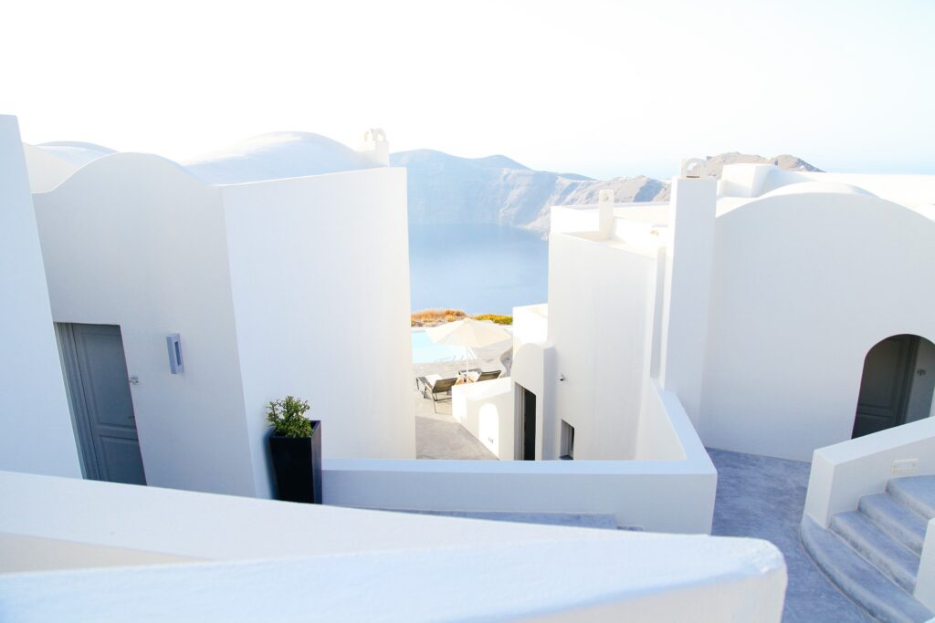 Blinding white buildings iconic to the travel bucket list country of Greece.