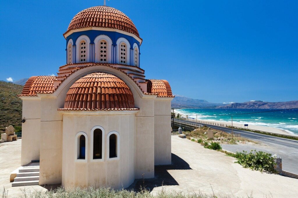 A Greek Orthodox church located next to the sea.