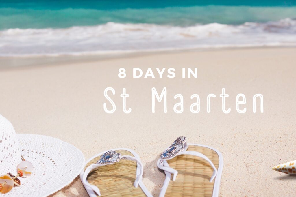 Clean sand with beach hat and sandals overlooking a blurred sea.