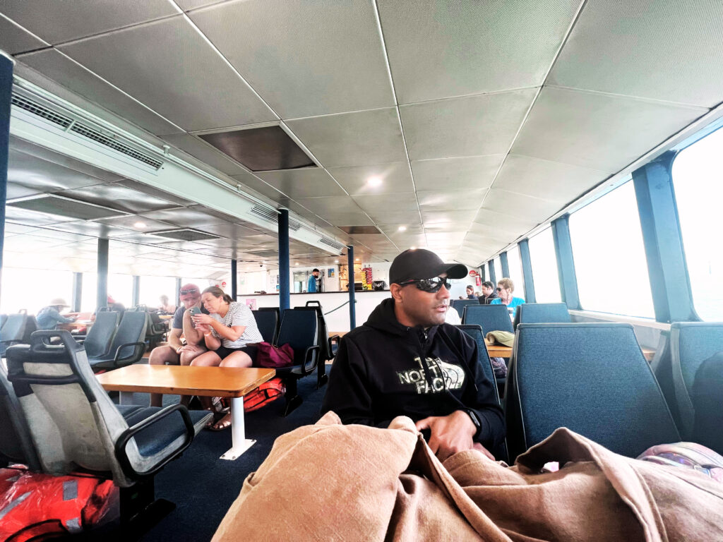 Table and seats inside the lower deck of a ferry.