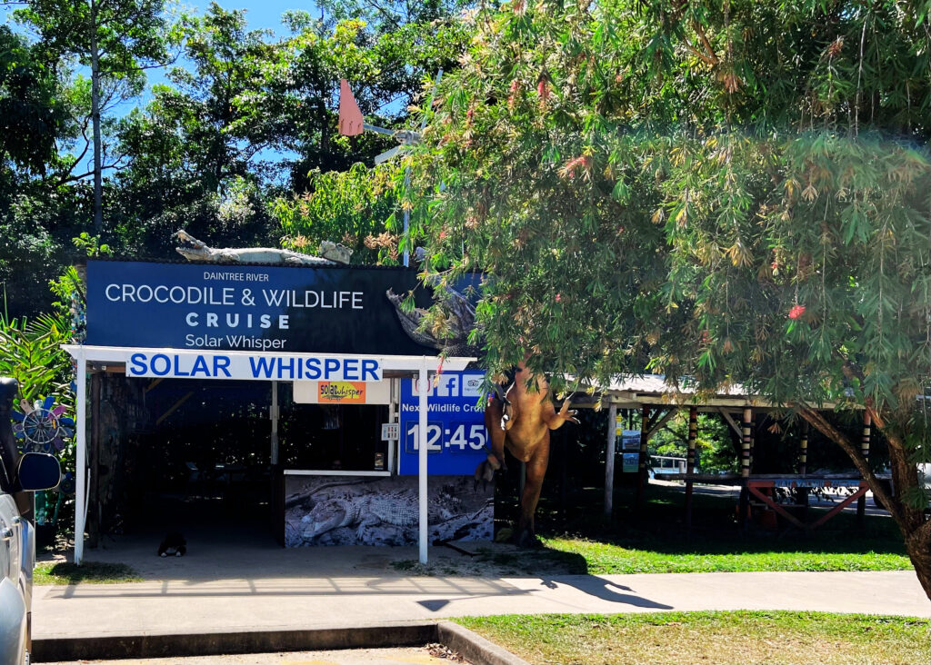 Exterior of building with sign for Daintree River cruise on the Solar Whisper.