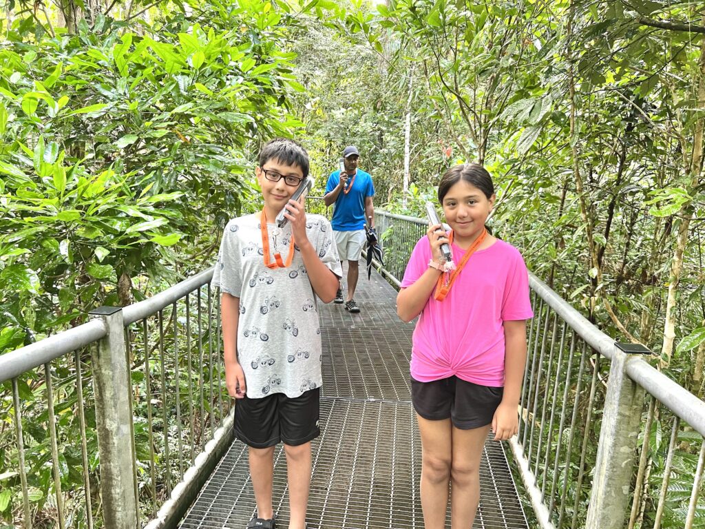 Children holding audio guides on the aerial platform at the Daintree Discovery Centre.