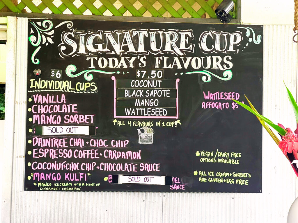 Ice cream menu sign written in colorful chalk.