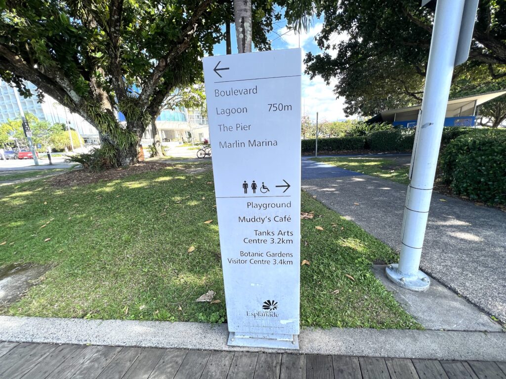 Sign indicating local directions along a boardwalk.