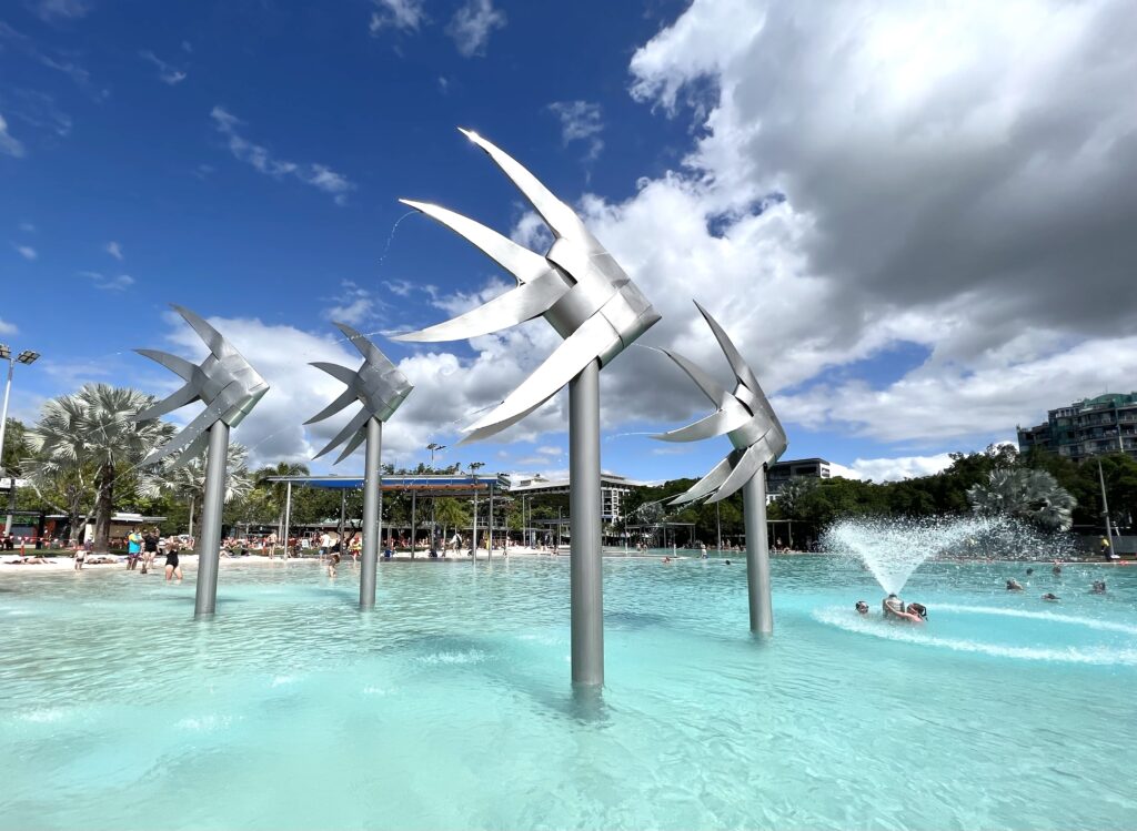 Unique statues shaped like fish standing in the Cairns Lagoon pool that you must visit on your 5 days in Tropical North Queensland trip.