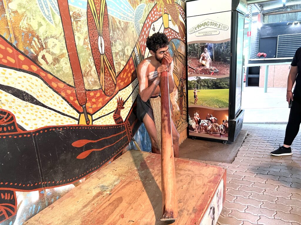 Australian aboriginal demonstrating how to play the didgeridoo, a must experience during 5 days in Tropical North Queensland.