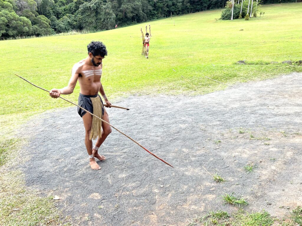 Australian aboriginal demonstrating a long spear in his hand.