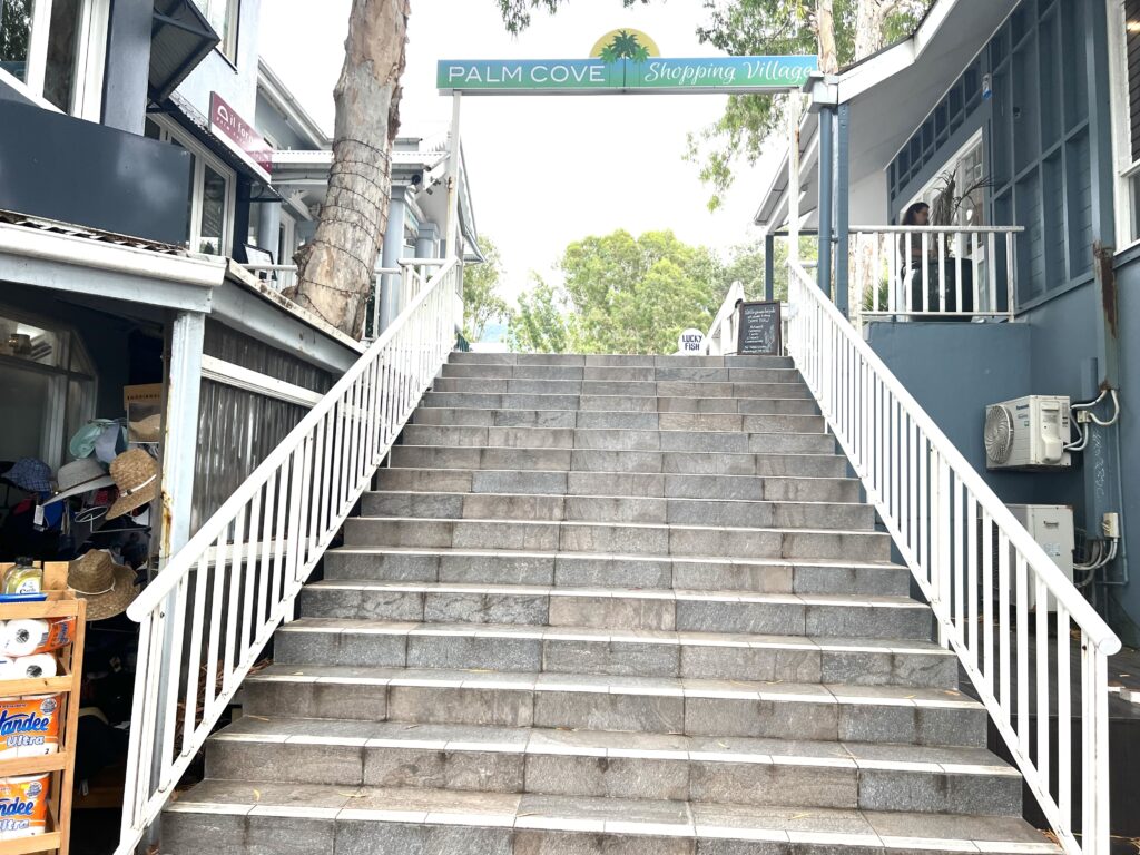 Cement steps leading up to small shops in Palm Cove, a place to visit on your 5 days in Tropical North Queensland trip.