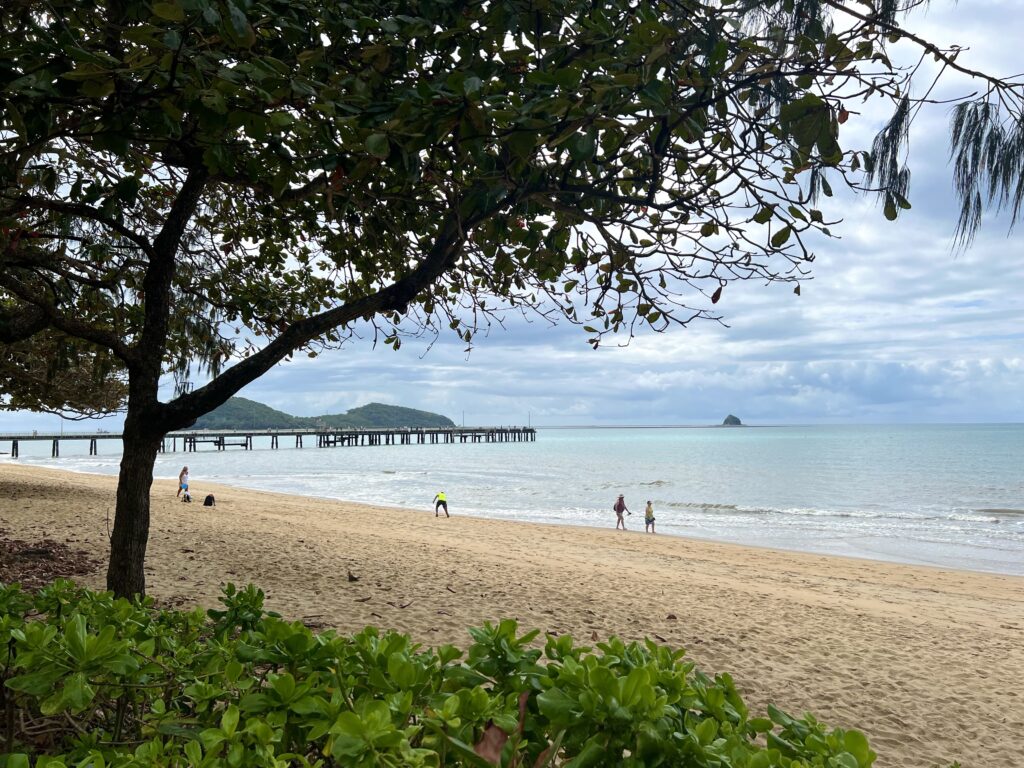 Beach next to sea with the Palm Cove Jetty stretching over water in distance, a stop on your 5 days in Tropical North Queensland trip.