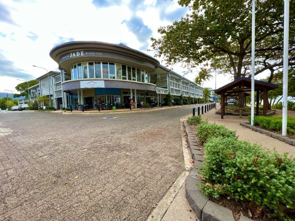 Storefronts in building along a paved road.