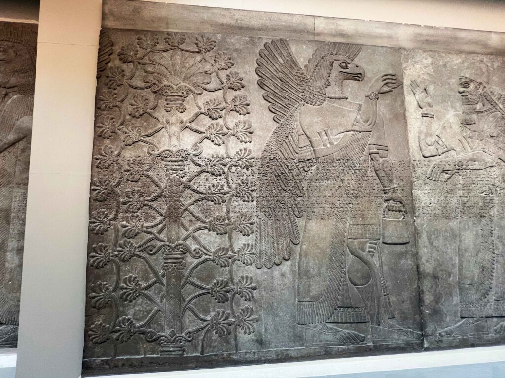 Intricate Assyrian carving displayed in British Museum.