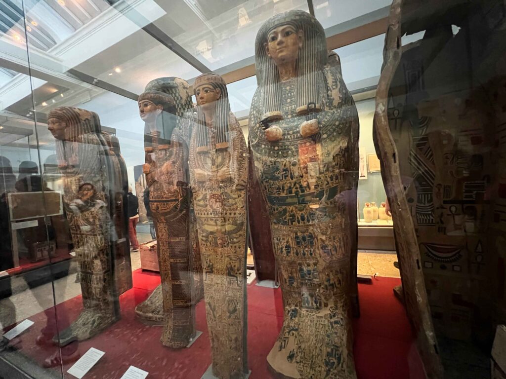 A display case housing standing mummies in the British Museum, a must see when in London with teens.