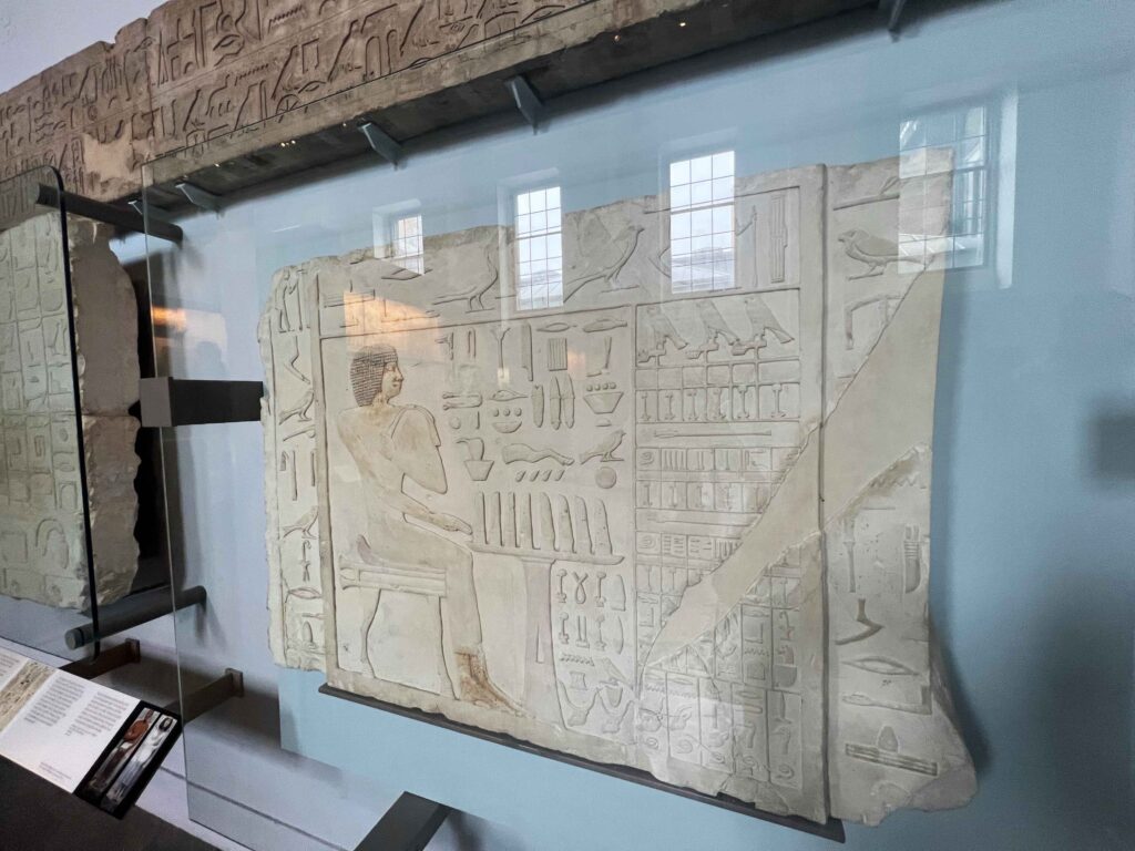 A display case housing Egyptian carvings in the British Museum.