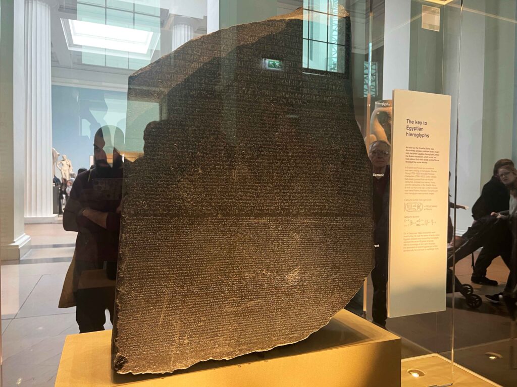 The famous Rosetta Stone in a display case at the British Museum.
