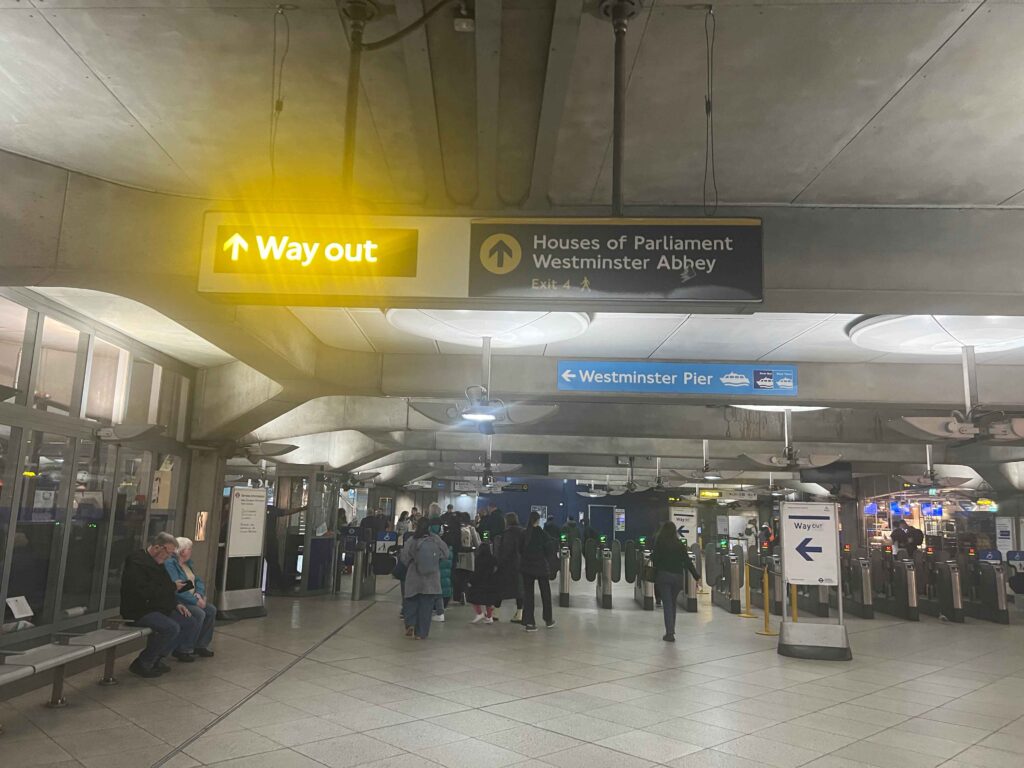 People moving through an underground tube station in London.