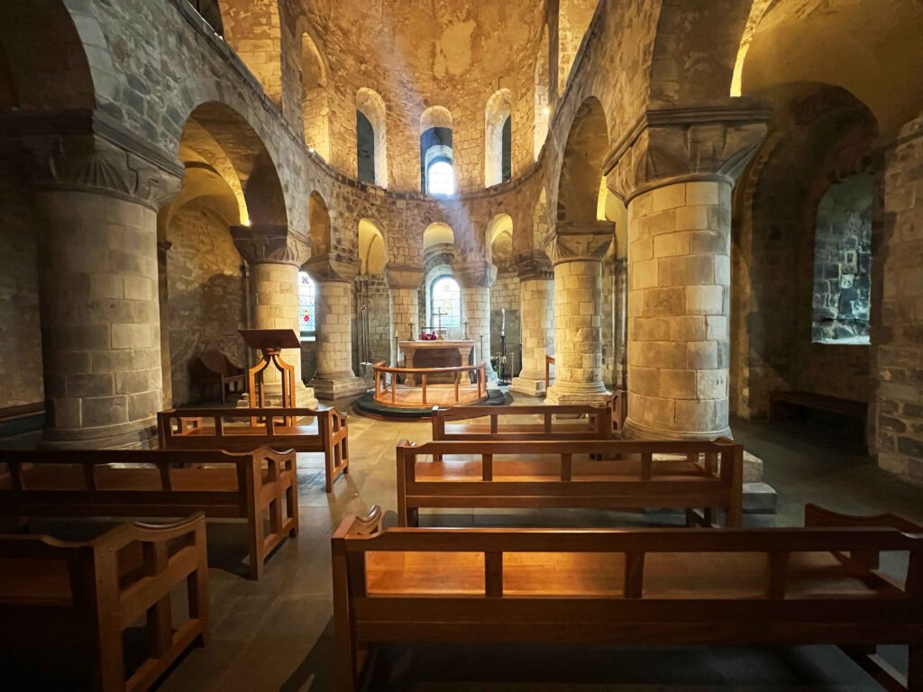 The inside of a two story stone chapel.