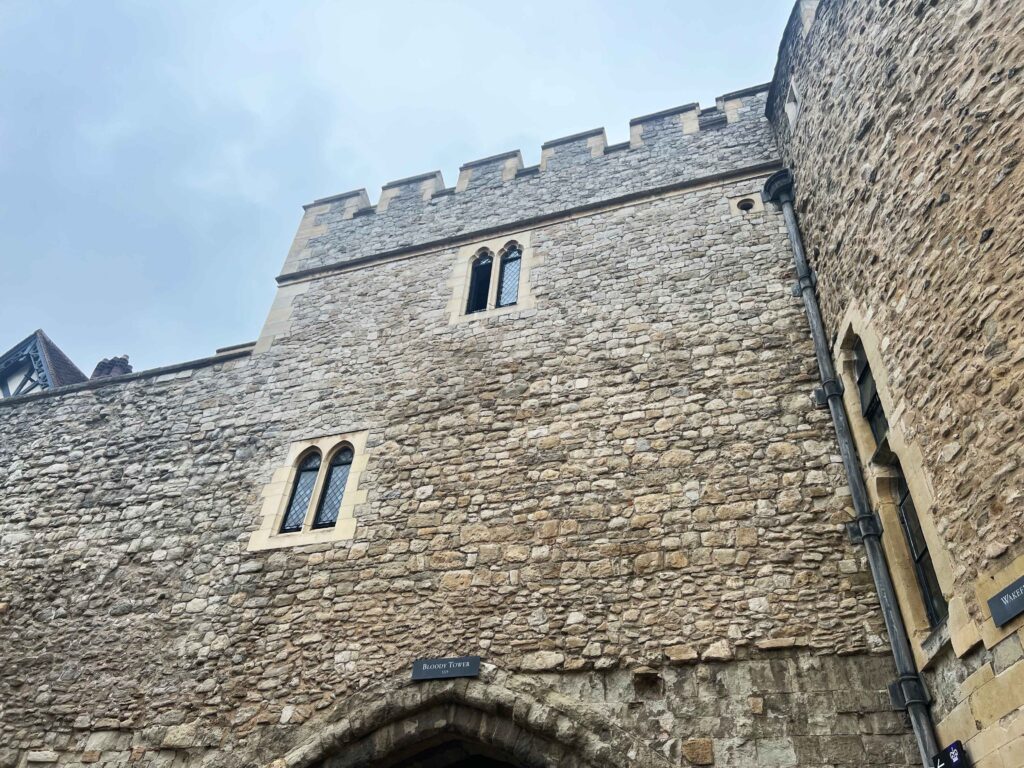 Looking up at a tall stone tower named the Bloody Tower.