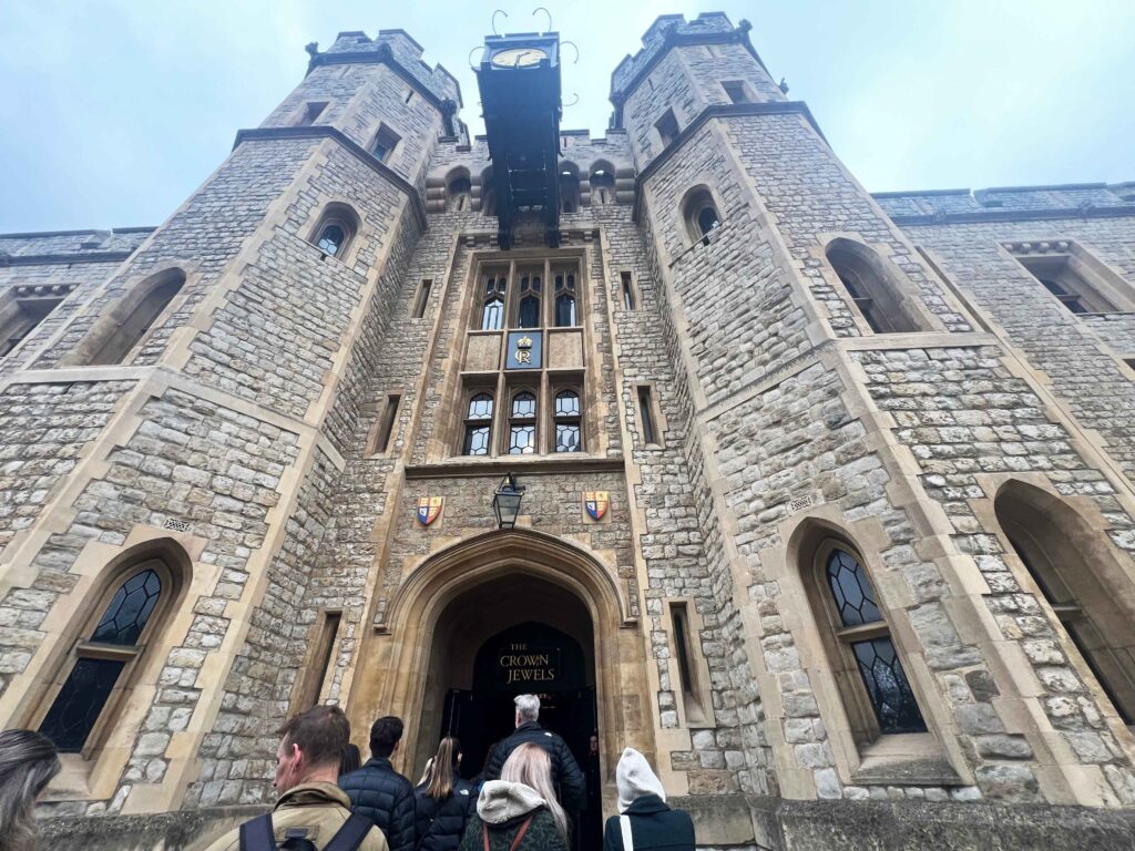 The tall stone building entrance to see the crown jewels at the Tower of London.