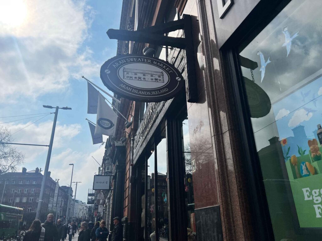 Sign for Aran Sweater Market hanging outside a store you may visit on a stopover in Ireland.