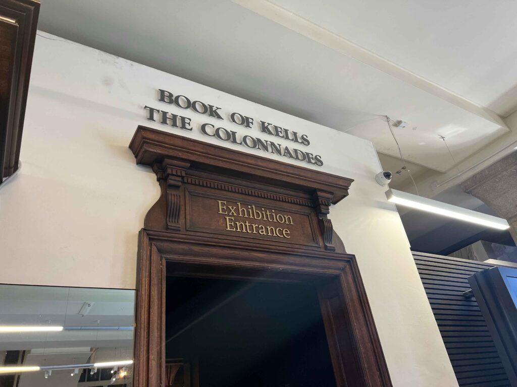 Sign above door indicating entrance to the Book of Kells, a must see on a stopover in Ireland.