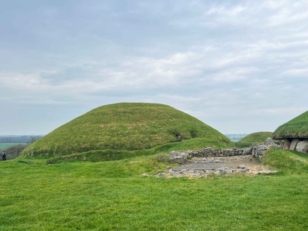 Large green mound on grassy knoll.