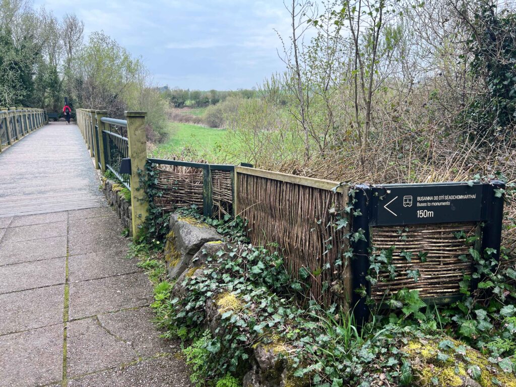 Pathway bridge over green pasture.
