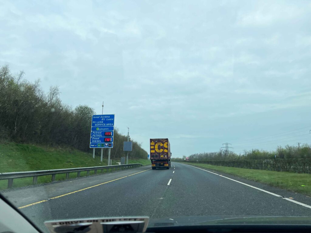 Semi driving on highway on a cloudy day.