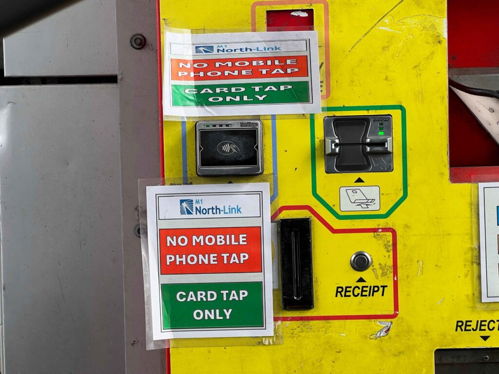 Yellow pay machine at a toll booth.