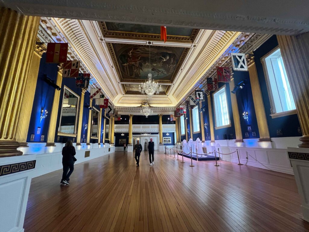 A large ballroom with blue and gold walls inside Dublin Castle.