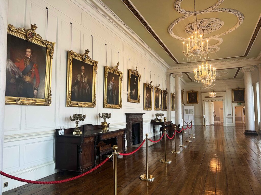 Several gold framed paintings of men in regal dress hung in a gallery within Dublin Castle.