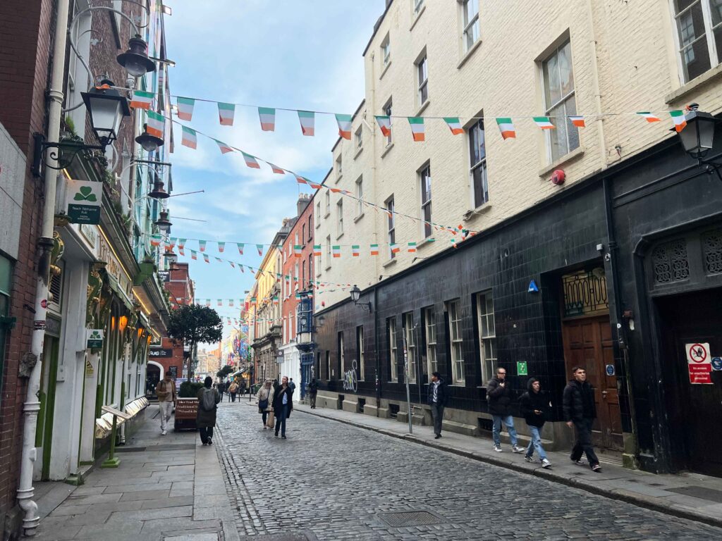 Irish flags strung across the street between buildings.
