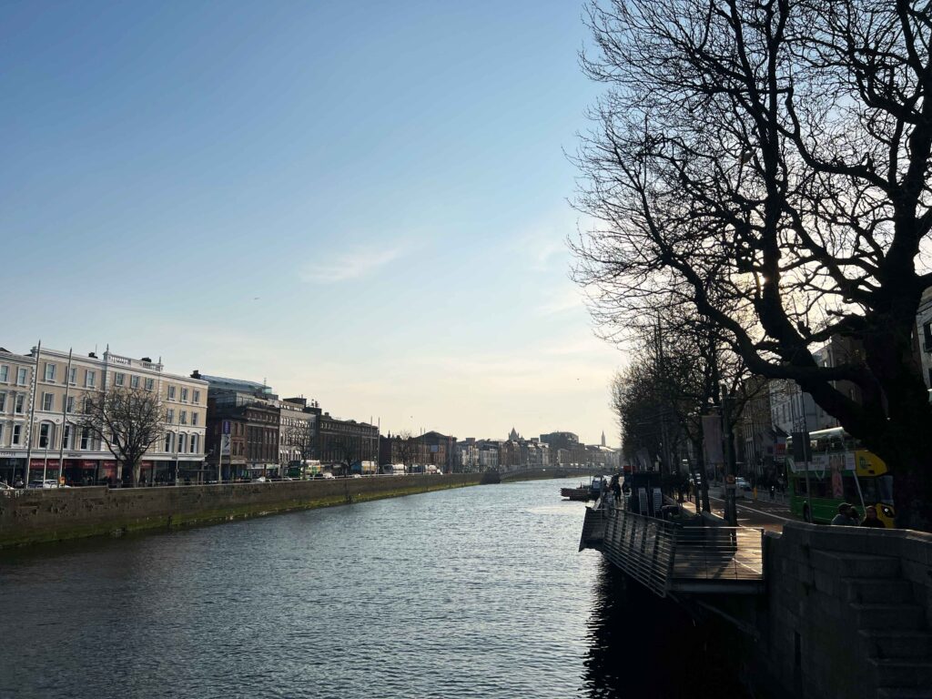 River between two streets lined with buildings.