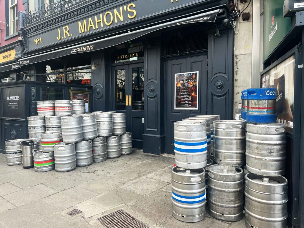 Beer barrels stacked outside a pub.