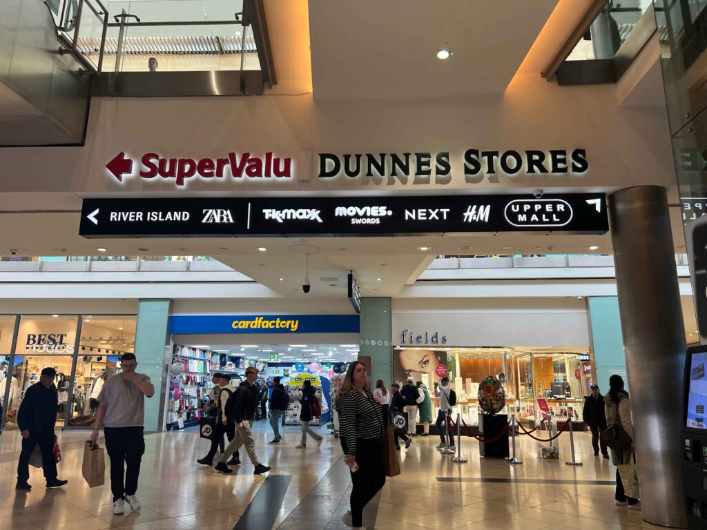 Inside a shopping mall with people shopping.