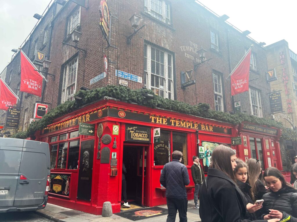 Old brick buliding with bright red lower half housing a bar in Dublin.
