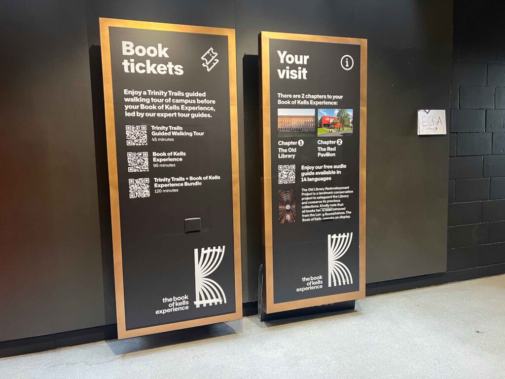 Two large signs explaining how to buy tickets for a campus tour, a must do on a stopover in Ireland.