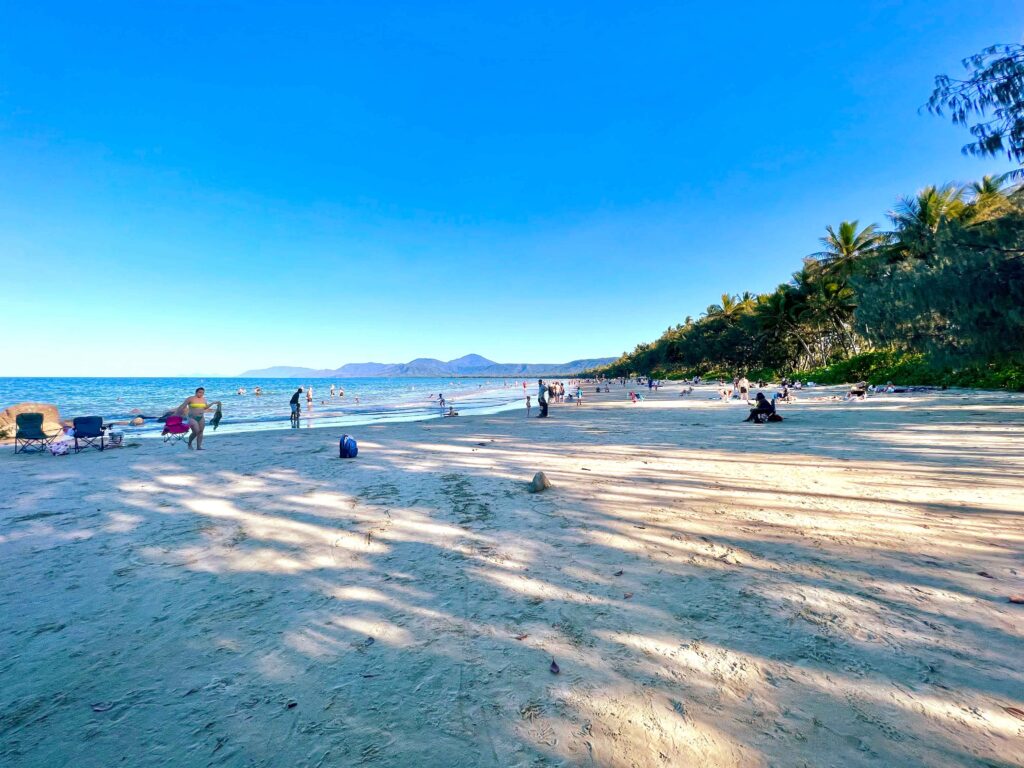 Long shadows across a wide beach at sunset.
